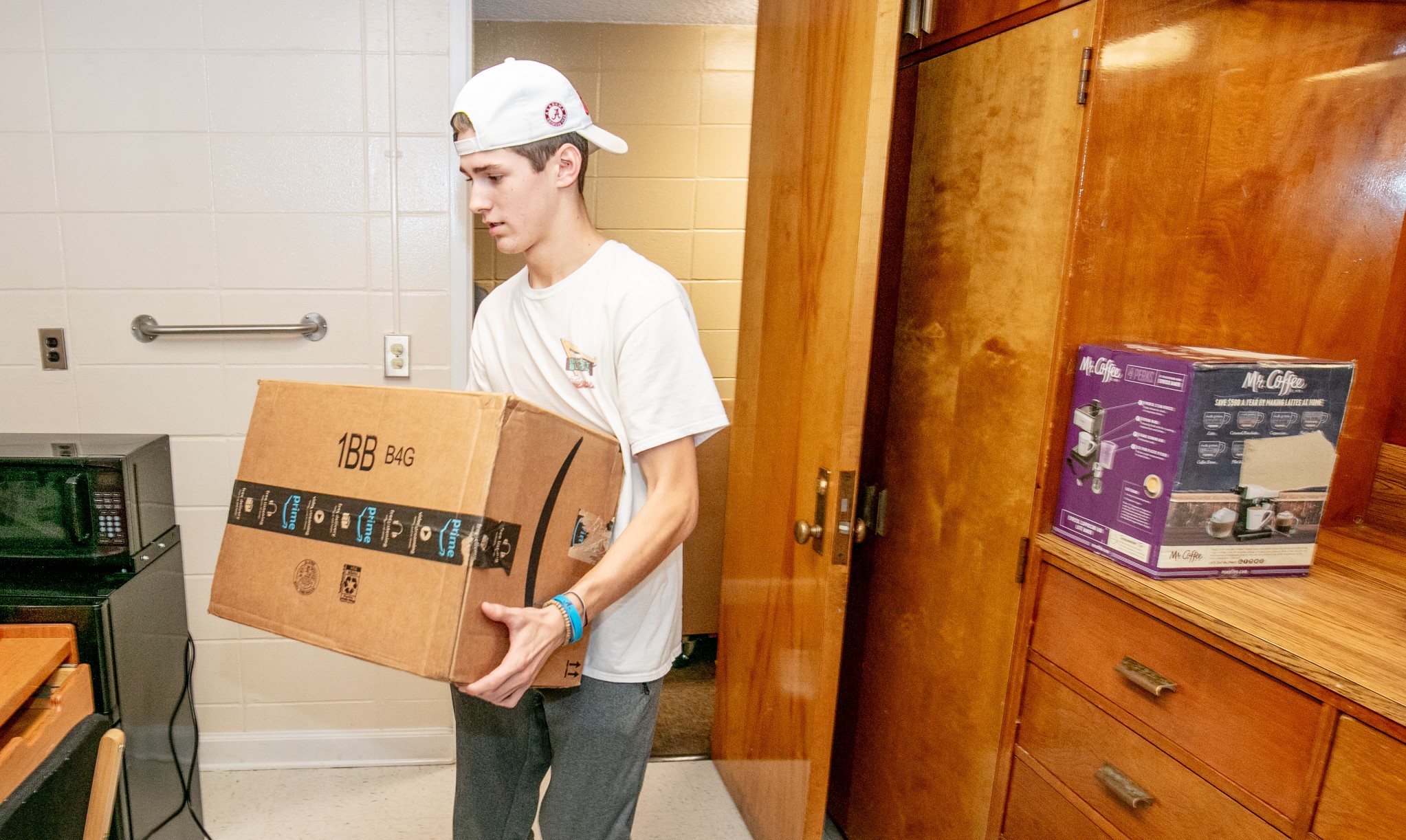 student holding Amazon box